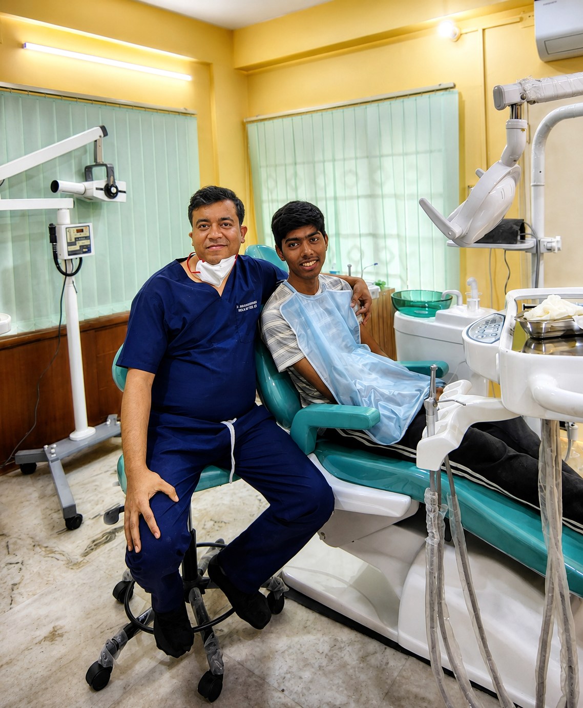 Dr. Anandam Bandyopadhyay with a young patient at Kolkata Smiles, Dum Dum, Kolkata